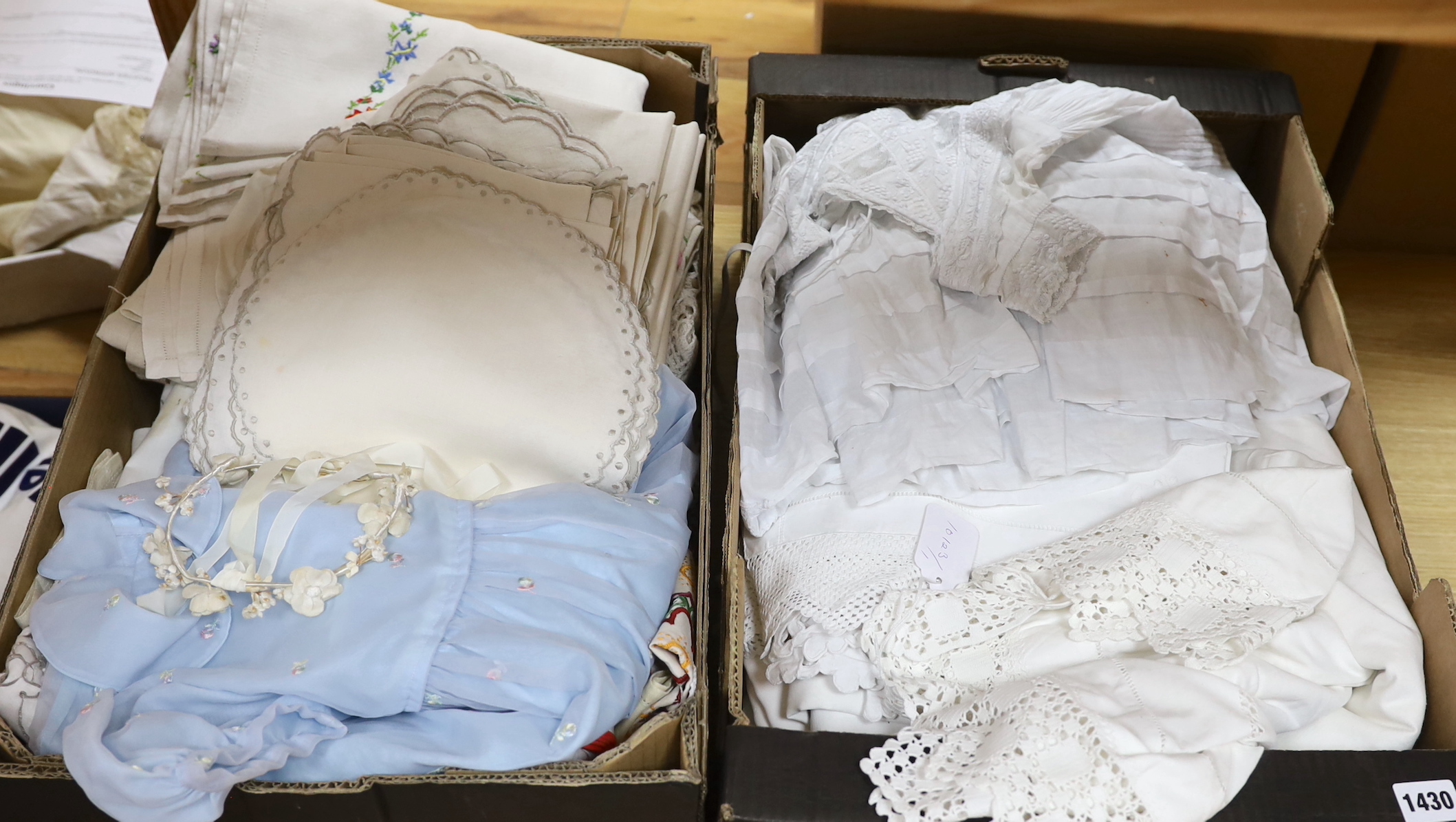 A 19th century white worked and hand made lace christening gown with a collection of table linens and a collection of coloured embroidered linens and a child's dress (2 boxes)